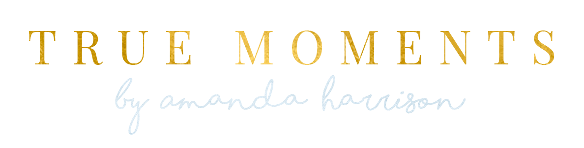 Gold “TRUE MOMENTS” text with faint script “by amanda harrison” on a white background