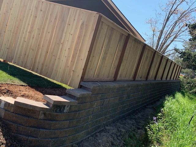 Wood privacy fence installed on landscape retaining wall blocks in Salem, OR