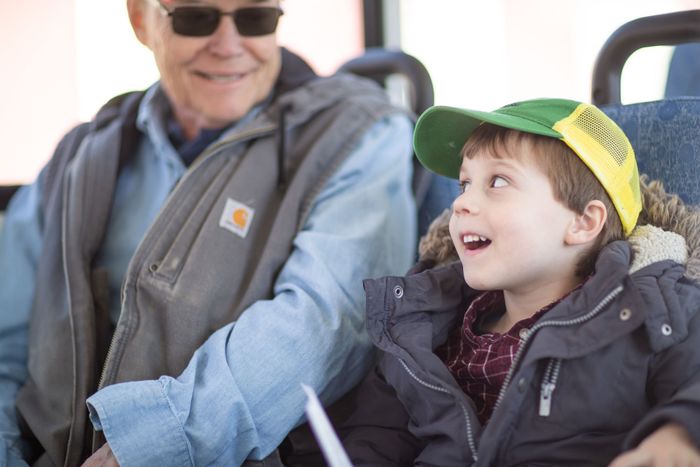 Photo of younger and older generations using Open Plains Transit services.