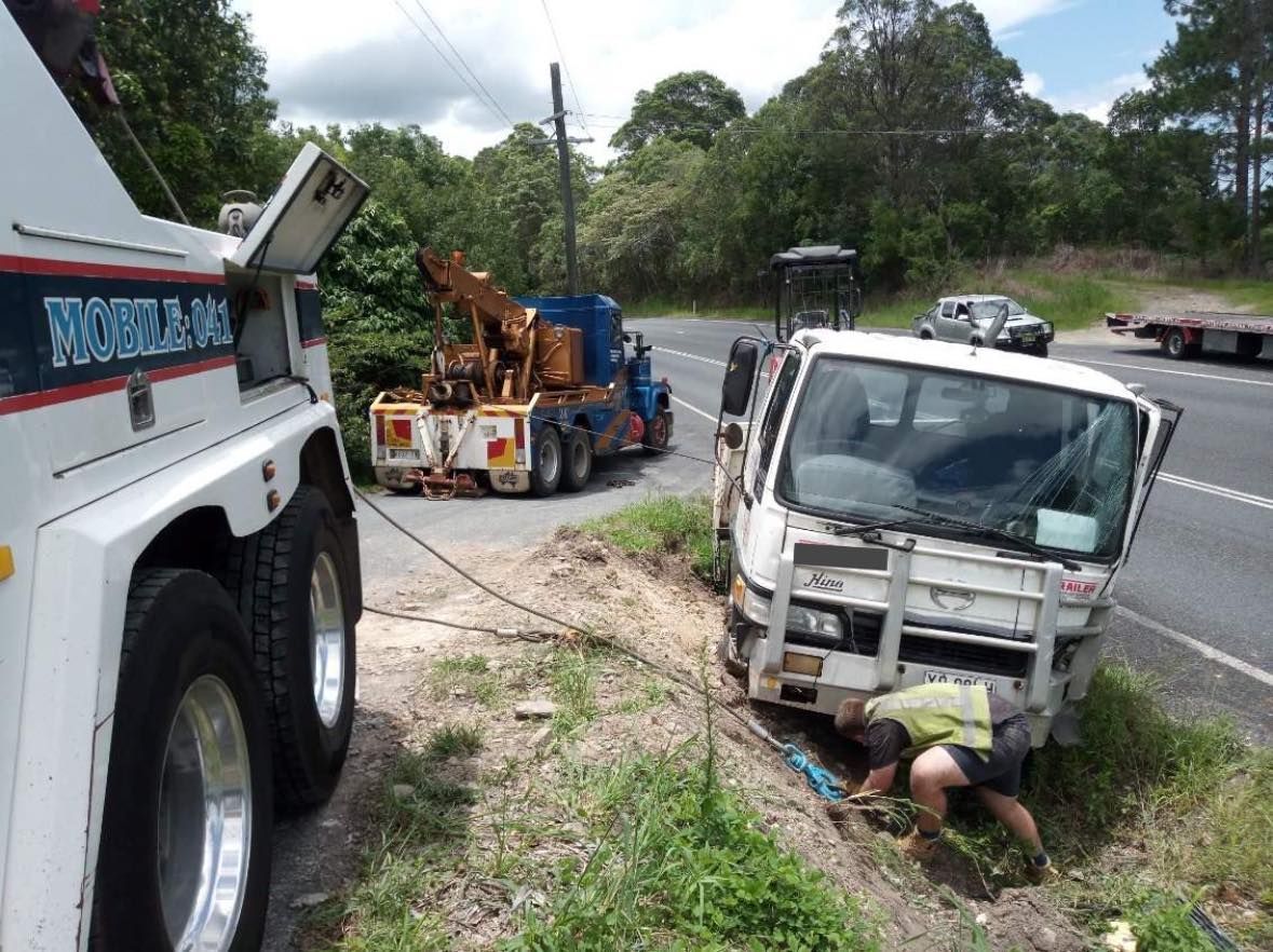 White Truck Overturned on Dirt Path Near Woods — Bangalow Towing in Bangalow, NSW