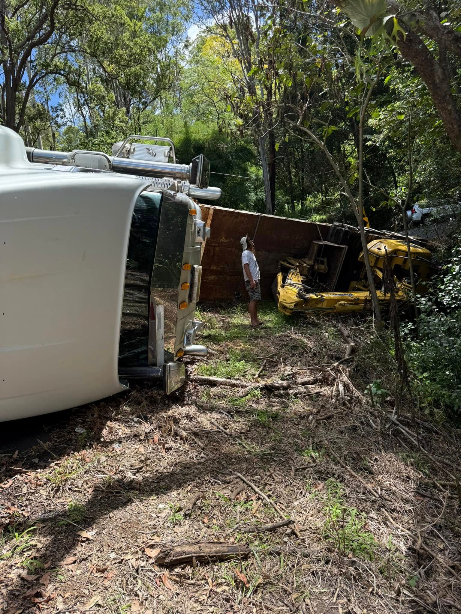 A semi-truck overturned on a road, with tow truck and workers present — Bangalow Towing in Bangalow, NSW