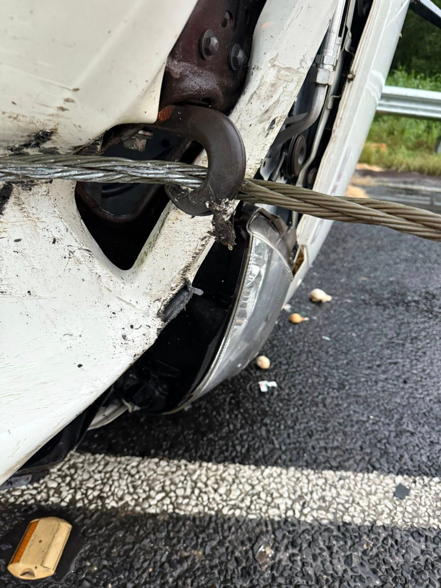 White Vehicle's Damaged Bumper With Tow Cable Attached — Bangalow Towing in Bangalow, NSW