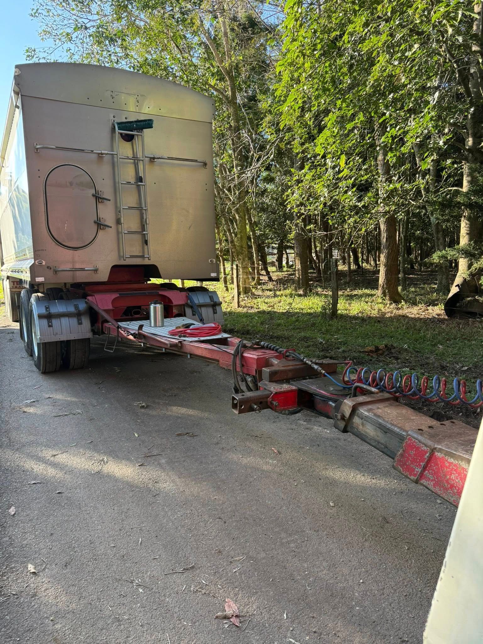 Red and Silver Trailer on a Gravel Road — Bangalow Towing in Bangalow, NSW