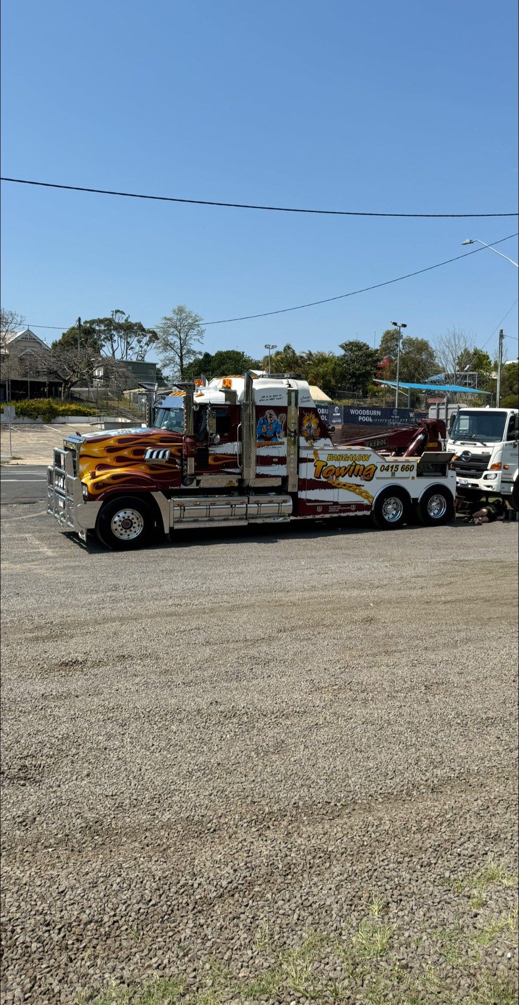 Colorful decorated truck parked on a gravel lot under a blue sky — Bangalow Towing in Bangalow, NSW