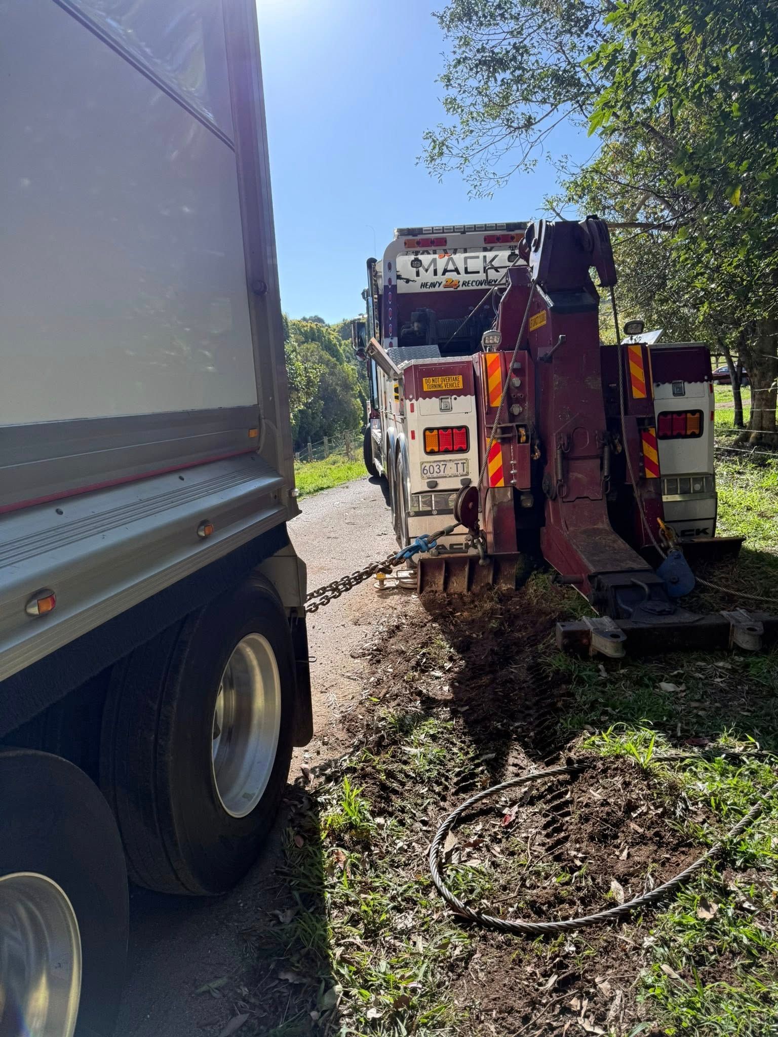 Tow Truck Pulling a Semi-trailer on a Dirt Road — Bangalow Towing in Bangalow, NSW