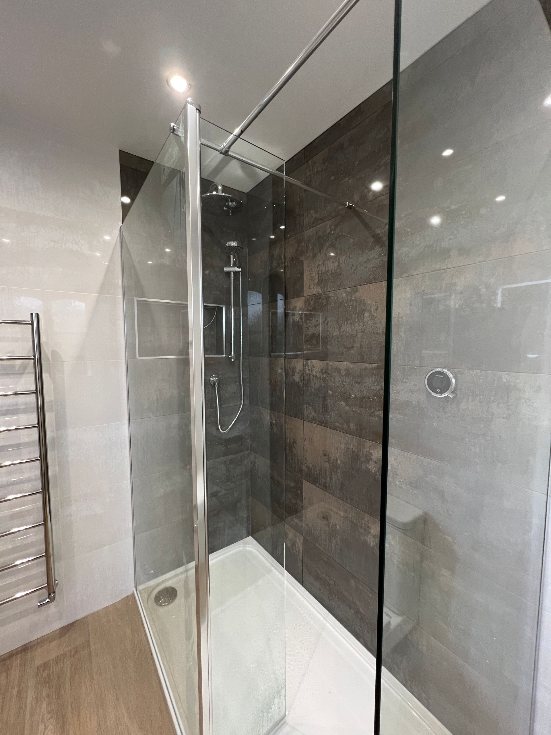 A bathroom with a walk in shower and a bathtub.