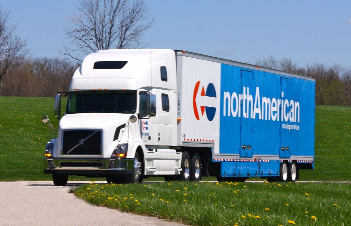 A north american semi truck is driving down a road