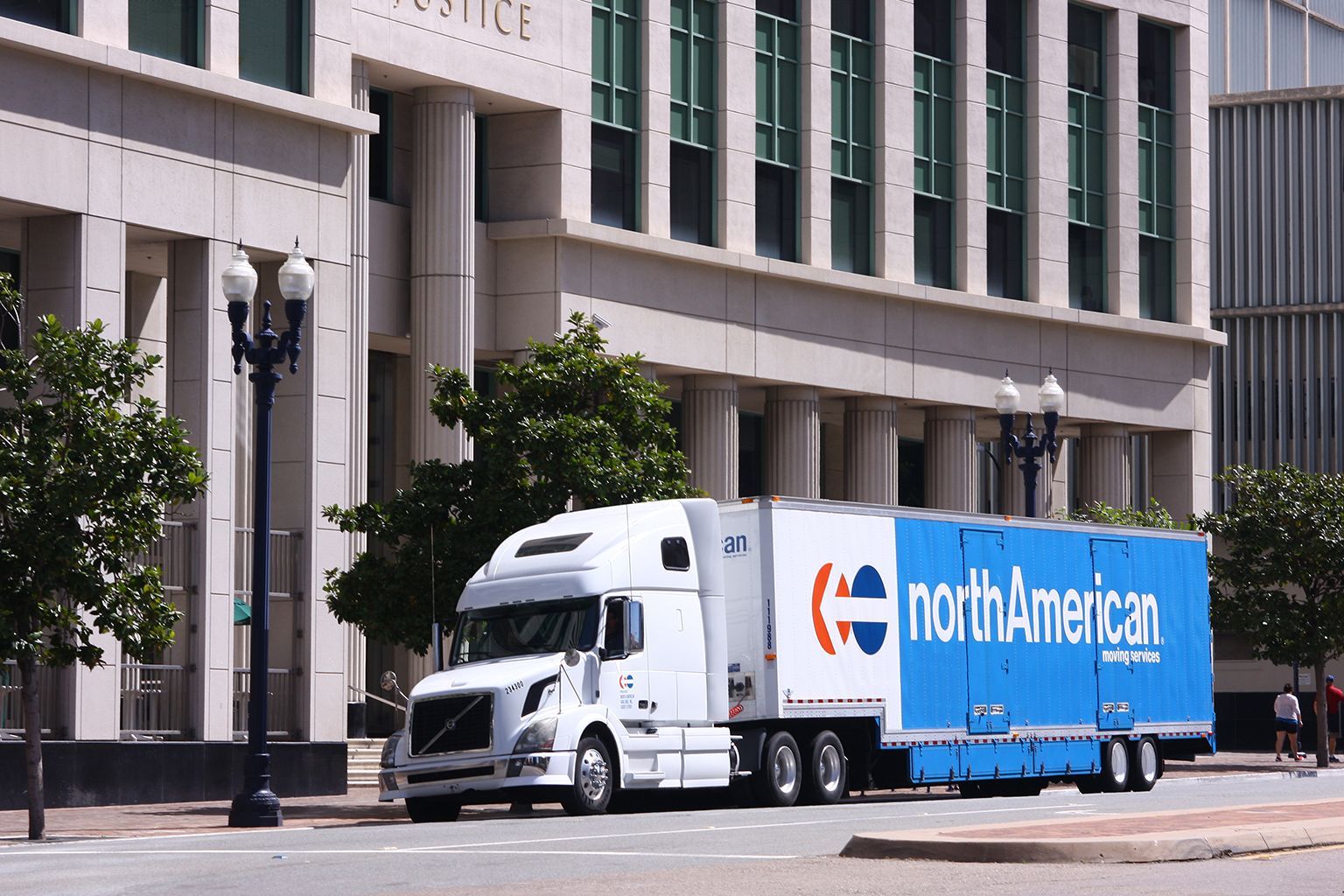 A north american truck is parked in front of a building