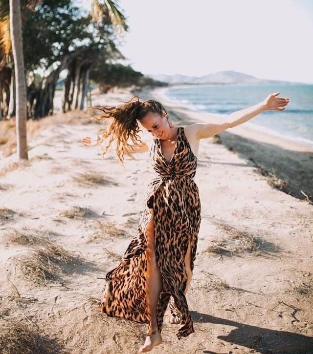 Girl dancing on the beach at Pallarenda Townsville. 