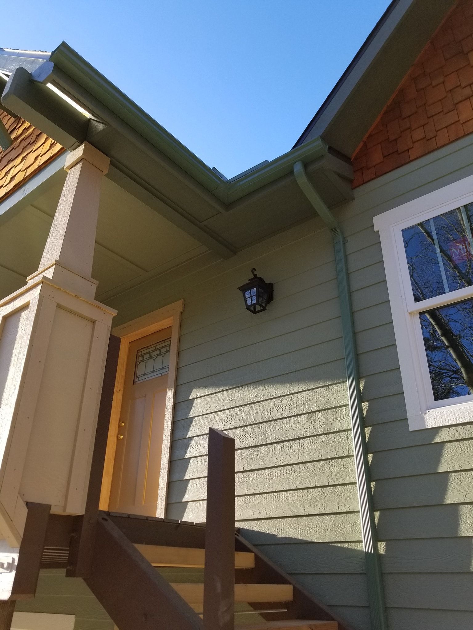 A house with stairs leading up to the front door