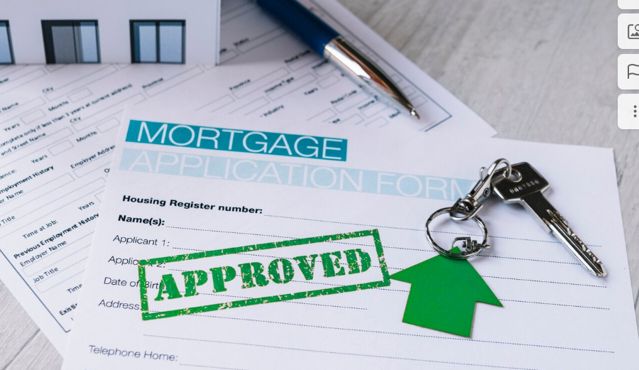 A mortgage application form with keys and a stamp that says approved