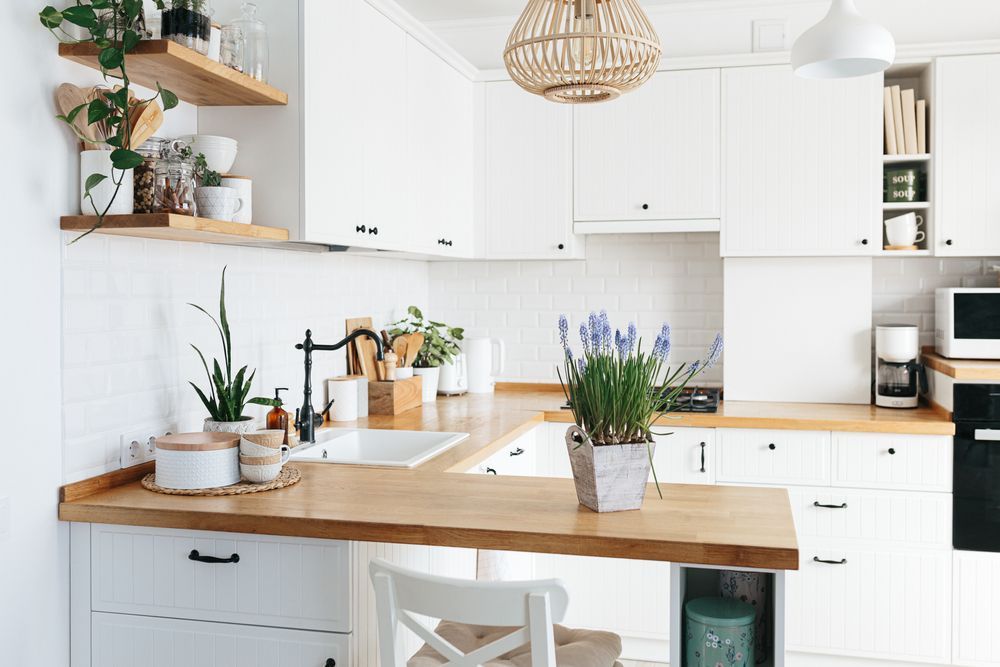 White Kitchen With Wooden Countertops — Dimond J Carpentry in Currimundi, QLD