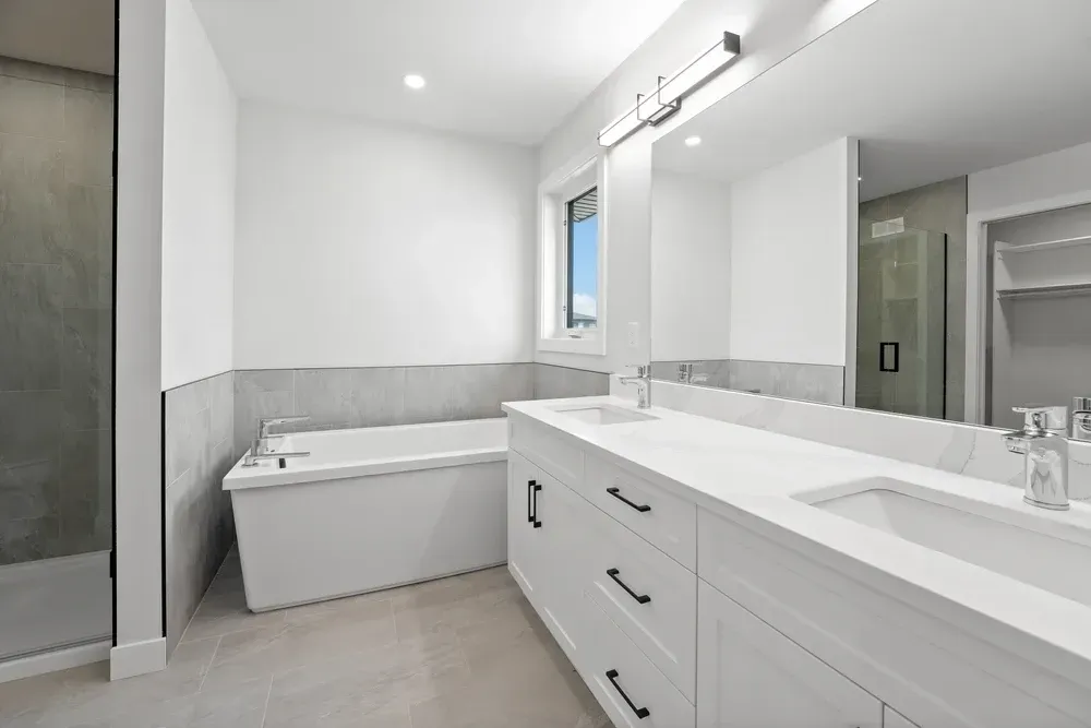 Modern white bathroom with a tub, vanity, and a glass shower. — Dimond J Carpentry in Bli Bli, QLD