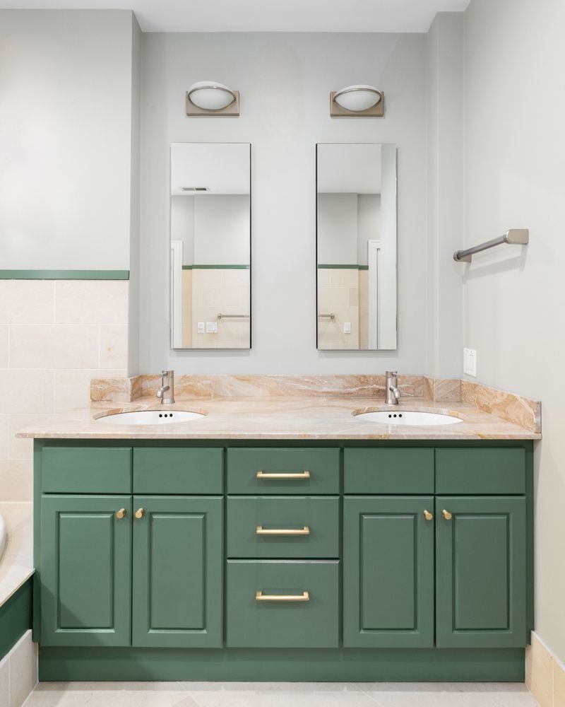 Green bathroom vanity with two mirrors, light fixtures, and a light-colored countertop. — Dimond J Carpentry in Nambour, QLD