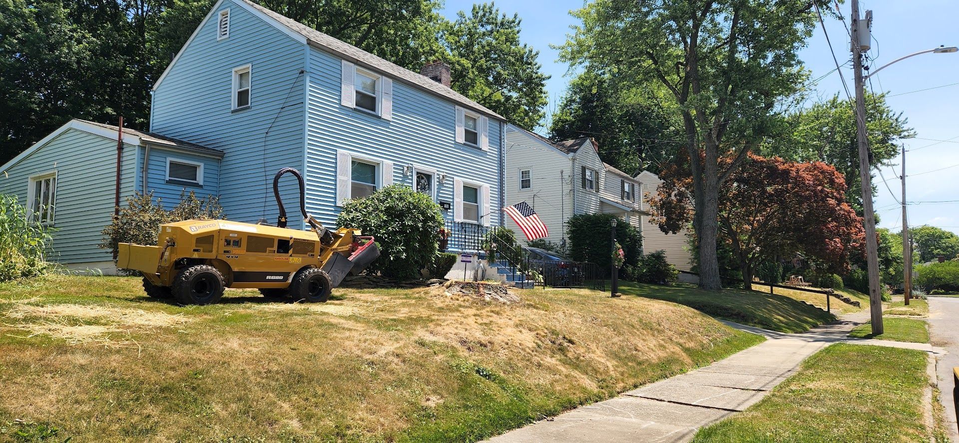 Yellow Truck is Parked in Front of a Blue House — Masury, OH — Hackett's Tree Service