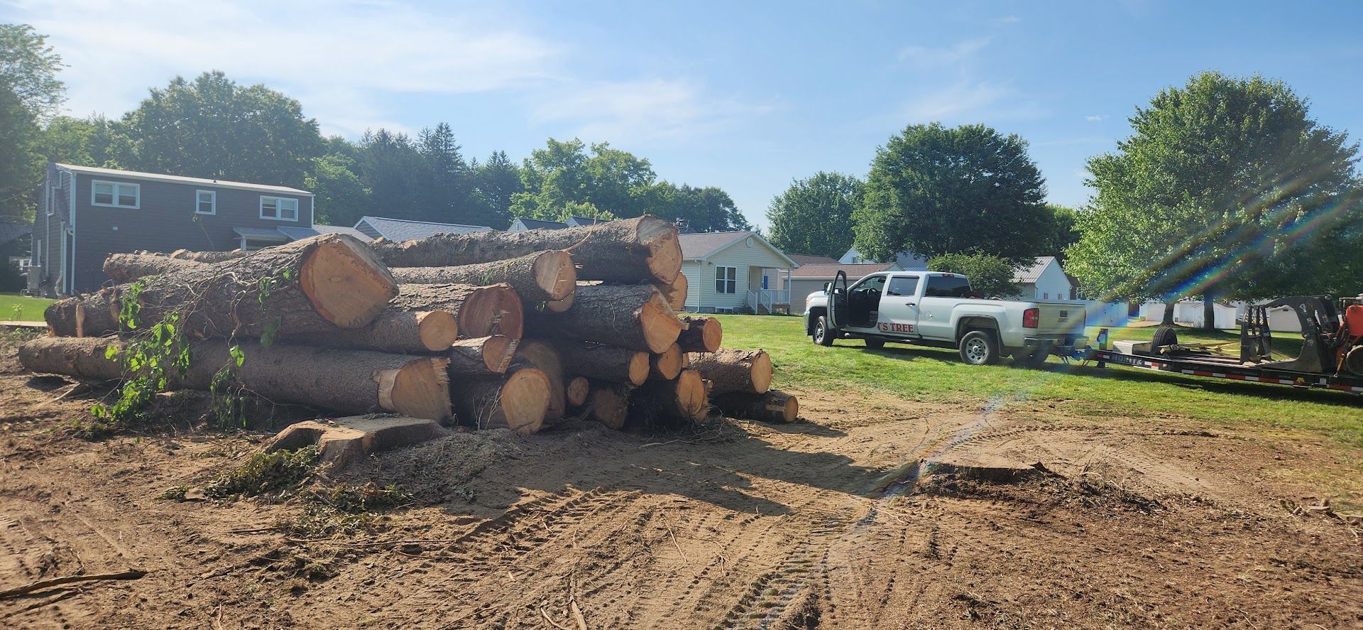 Pile of Logs is Sitting in a Dirt Field — Masury, OH — Hackett's Tree Service