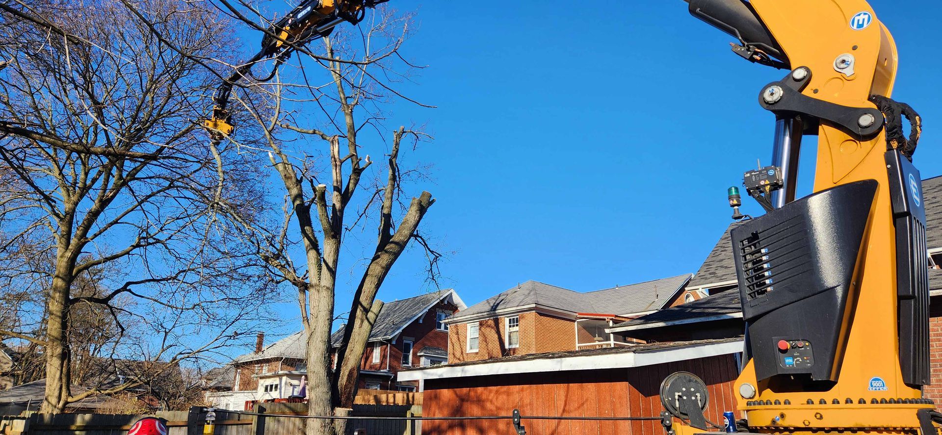 Crane is Cutting a Tree in Front of a House — Masury, OH — Hackett's Tree Service