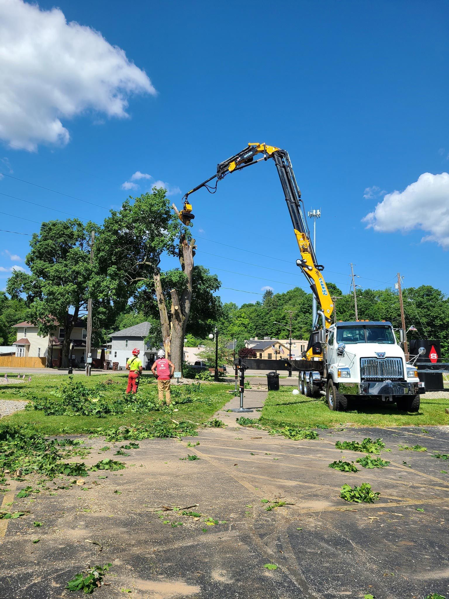 Truck With a Crane Attached to It is Cutting Down a Tree — Masury, OH — Hackett's Tree Service