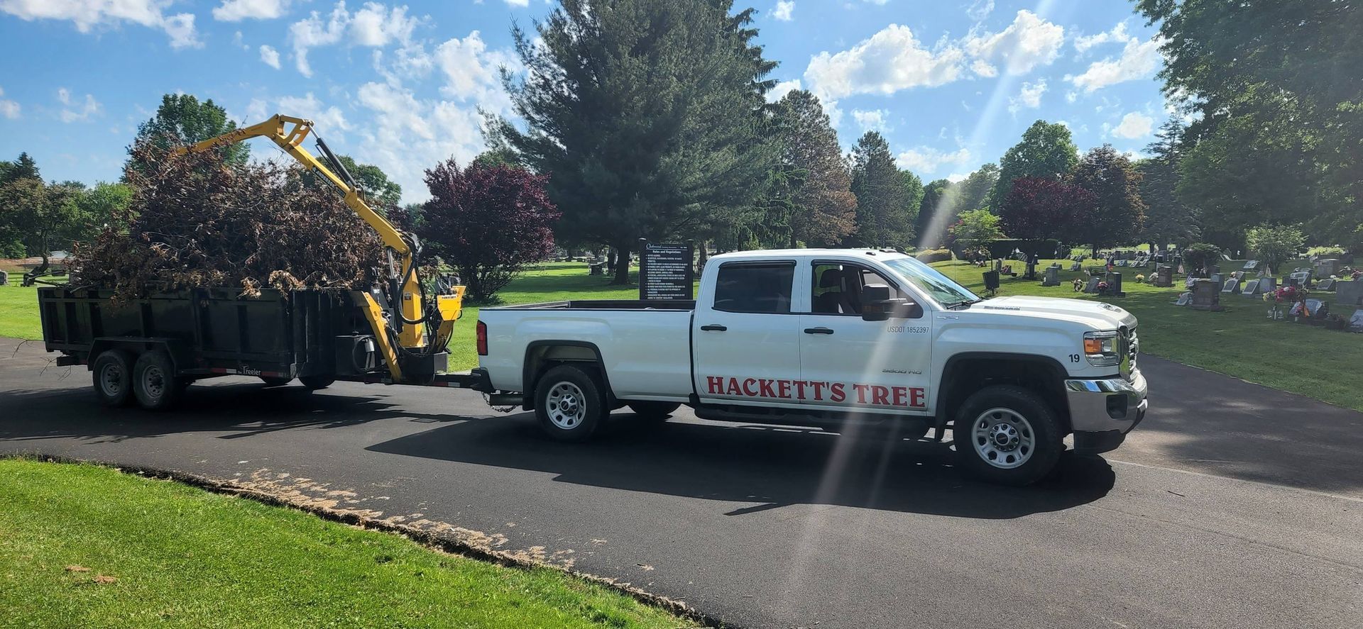 White Truck is Pulling a Trailer Full of Trees — Masury, OH — Hackett's Tree Service