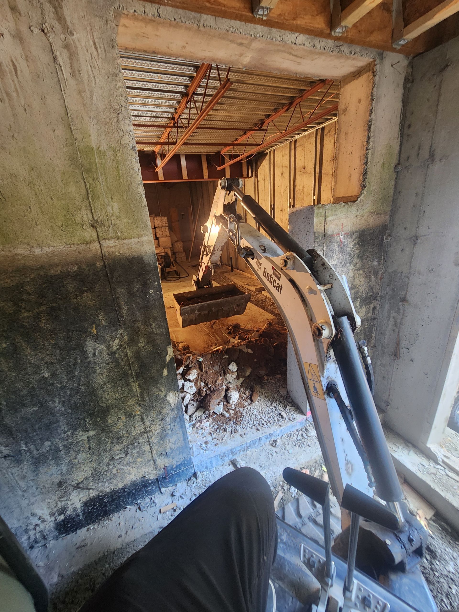 Une personne utilise une machine pour creuser un trou dans un mur.