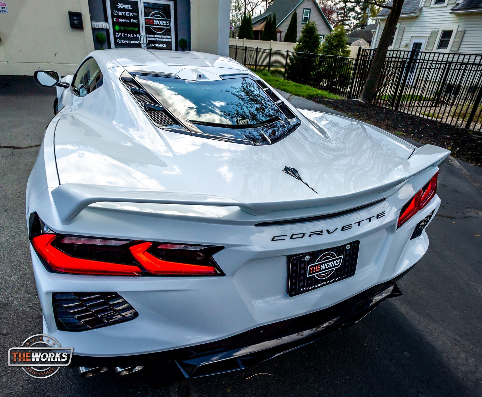 Certified technician applying paint protection film to a vehicle’s hood for long-term protection against chips, sun, and road debris.
