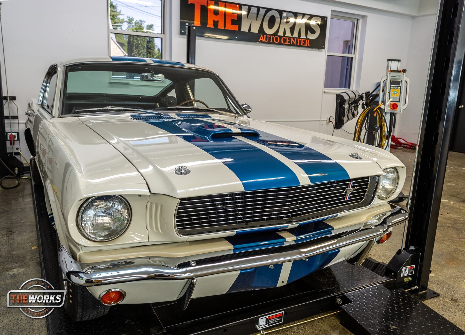 Certified technician applying paint protection film to a vehicle’s hood for long-term protection against chips, sun, and road debris.