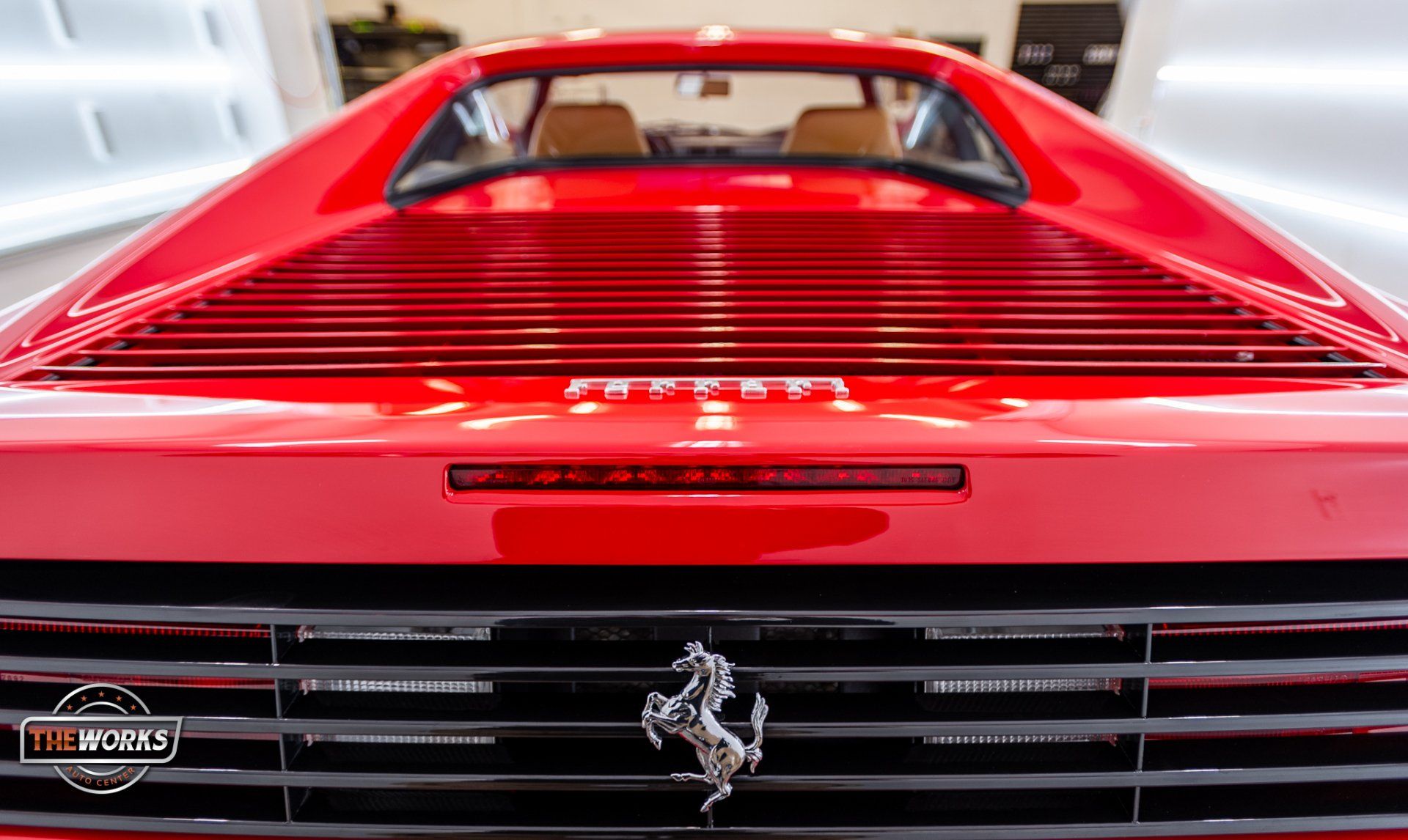 A close up of the front of a red ferrari sports car.