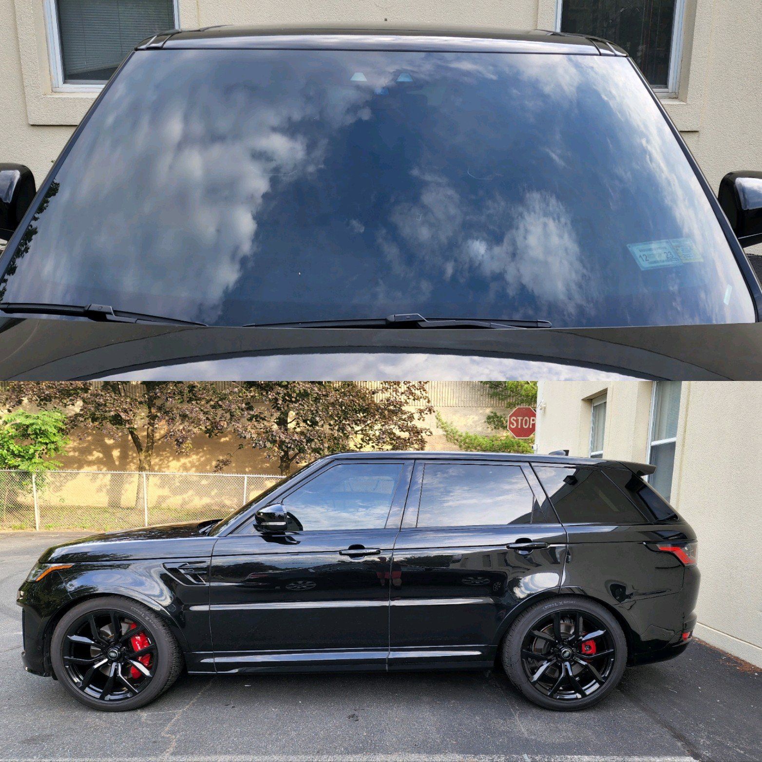 A black range rover sport is parked in front of a building.