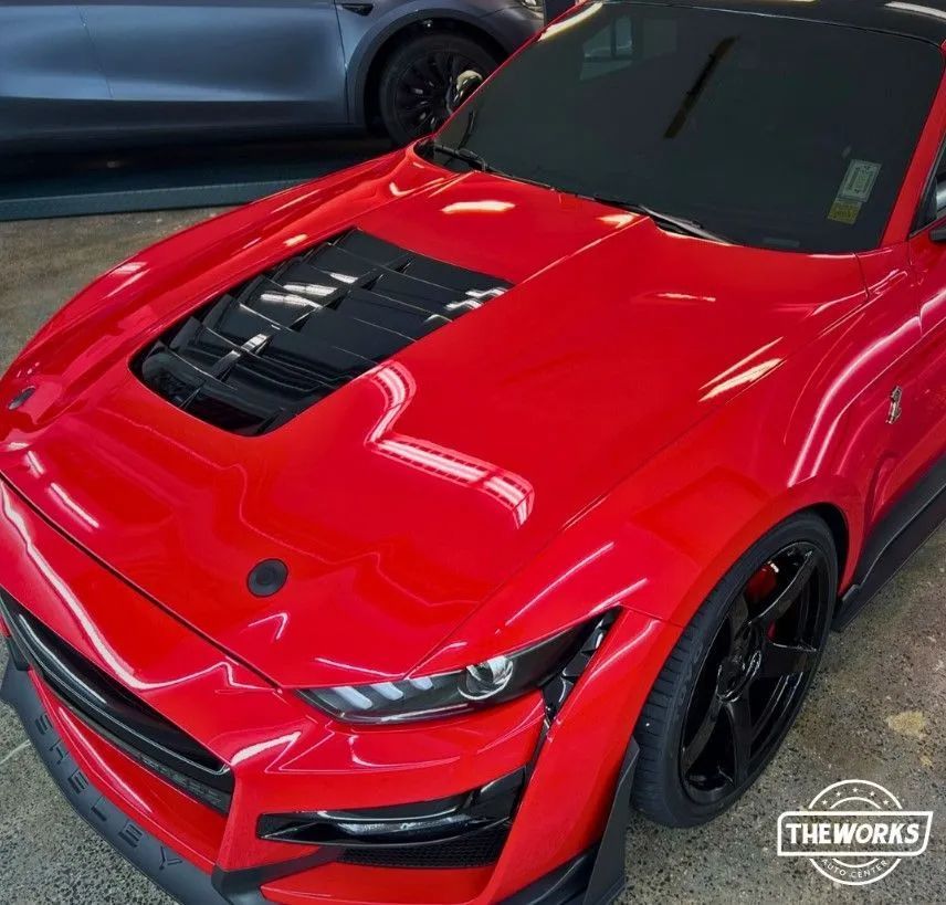 Vehicle with ceramic coating parked in Albany during fall, showcasing glossy finish.
