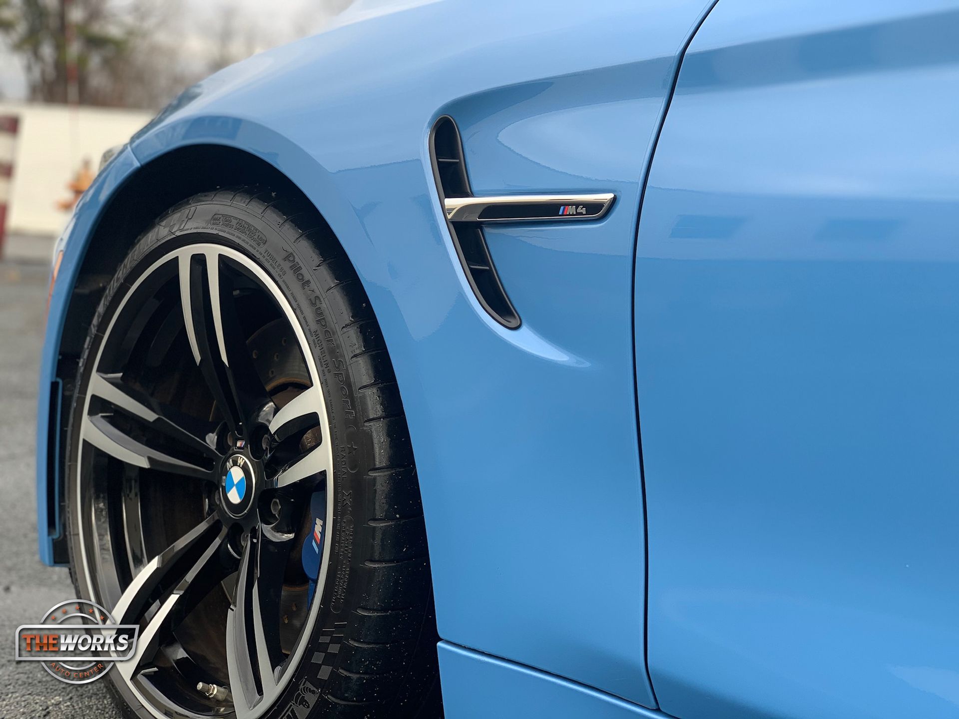 Detailer hand-washing a vehicle with pH-neutral soap and microfiber towel to protect the car ceramic coating and maintain high-gloss shine.