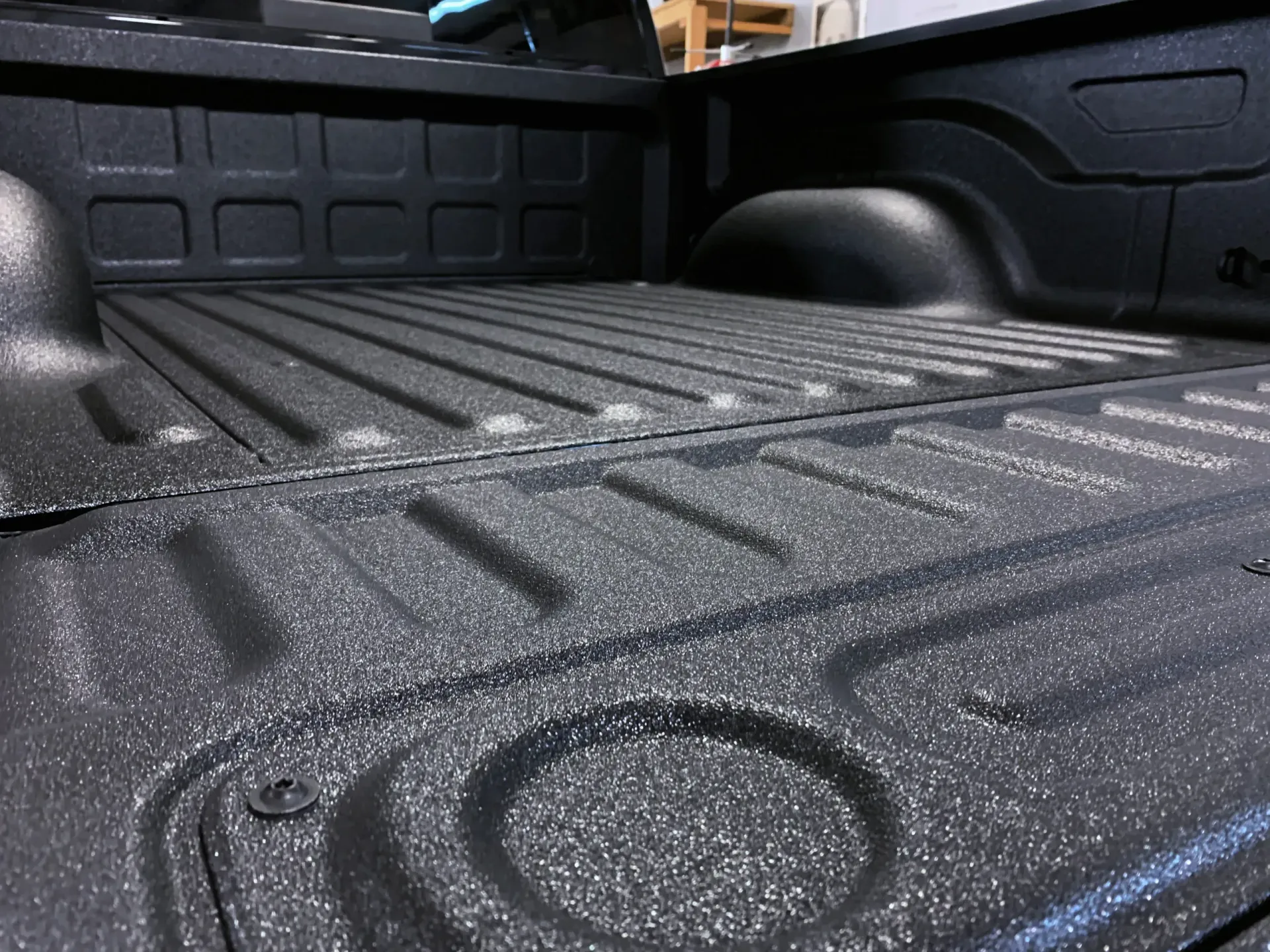 A close up of a truck bed painted black