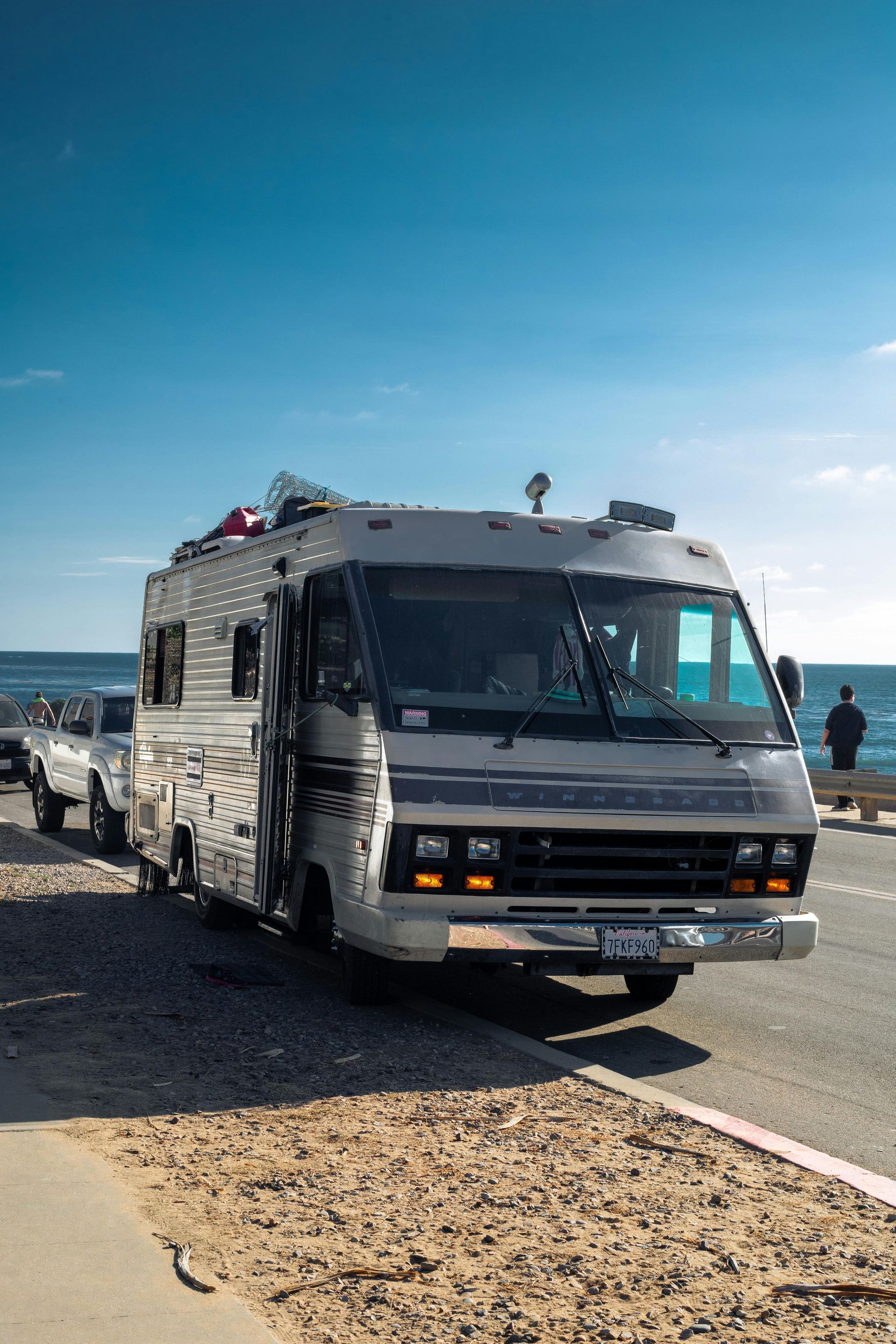Parked RV by ocean roadside