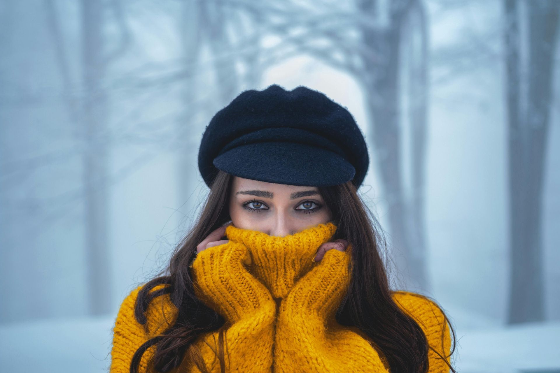 Woman in sweater covering face