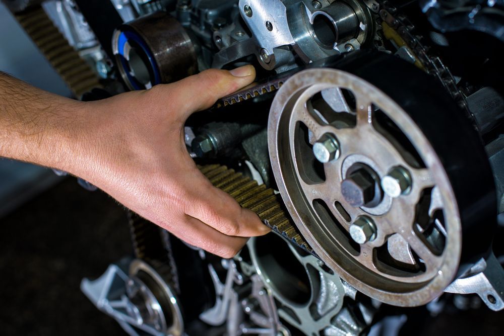 A Person is Fixing a Belt on a Car Engine — Mechanical World In Wagga Wagga, NSW