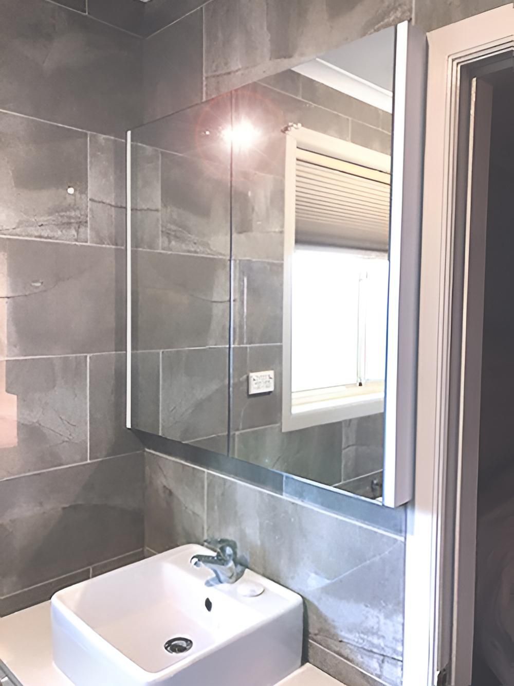 A Bathroom With a Sink, Mirror and Window — BM Cabinetry In Spring Grove, NSW