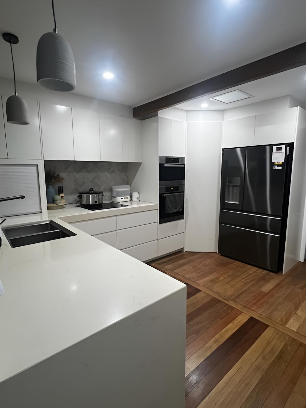A kitchen with white cabinets