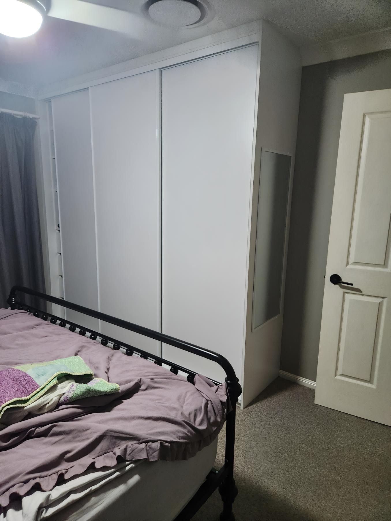 A Bedroom With a Bed and Sliding Glass Doors