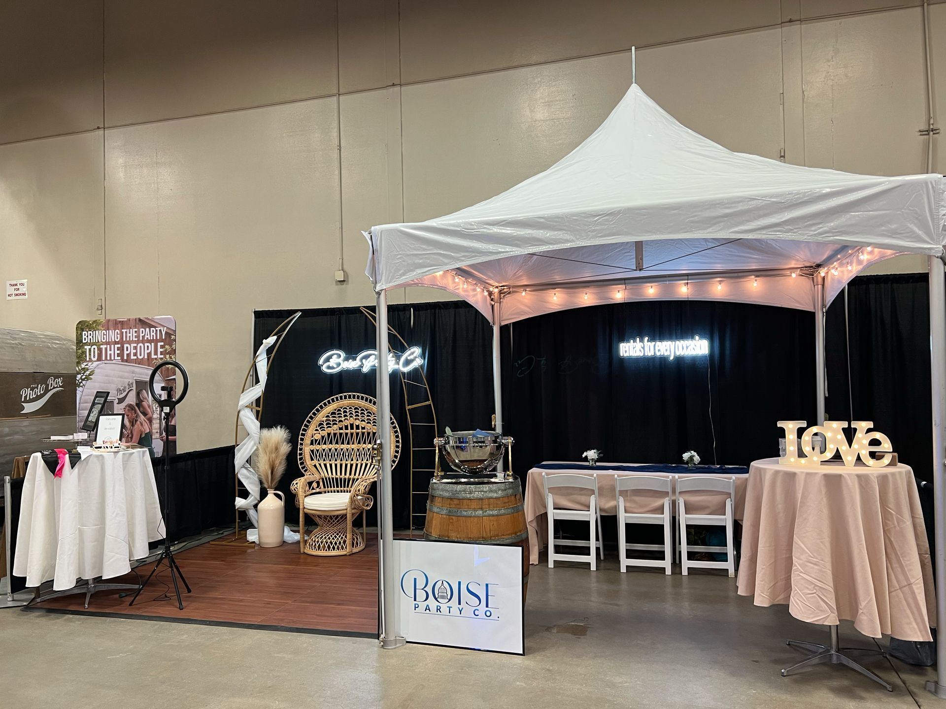 There is a tent in the middle of the room with tables and chairs.