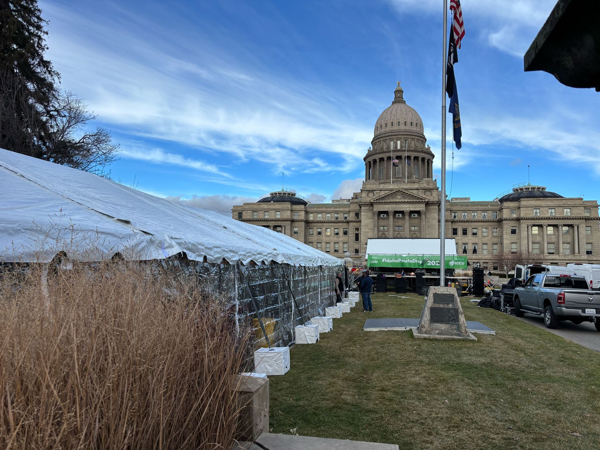 A tent is set up in front of a large building