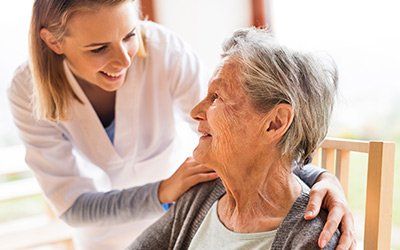 Senior Care — Caregiver Smiling Towards the Elder in Boward Country, FL