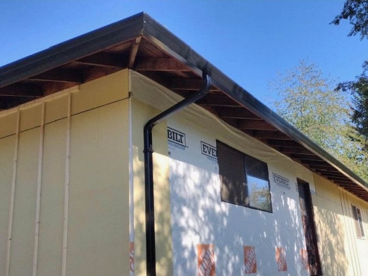 A house with a gutter on the side of it.