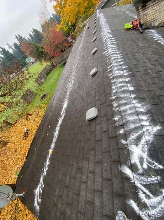 A roof with a lot of shingles on it is being repaired.