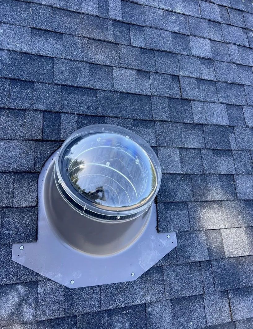There is a skylight on the roof of a house.