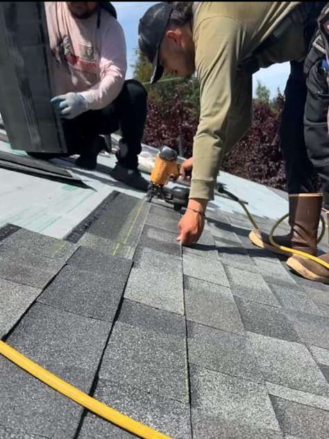 A group of people are working on a roof.