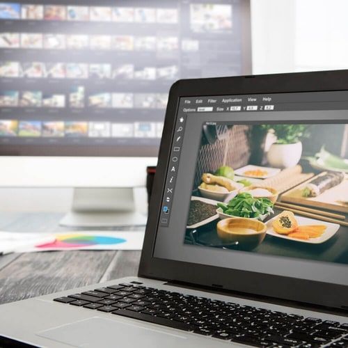 A laptop computer is open to a picture of food on the screen.