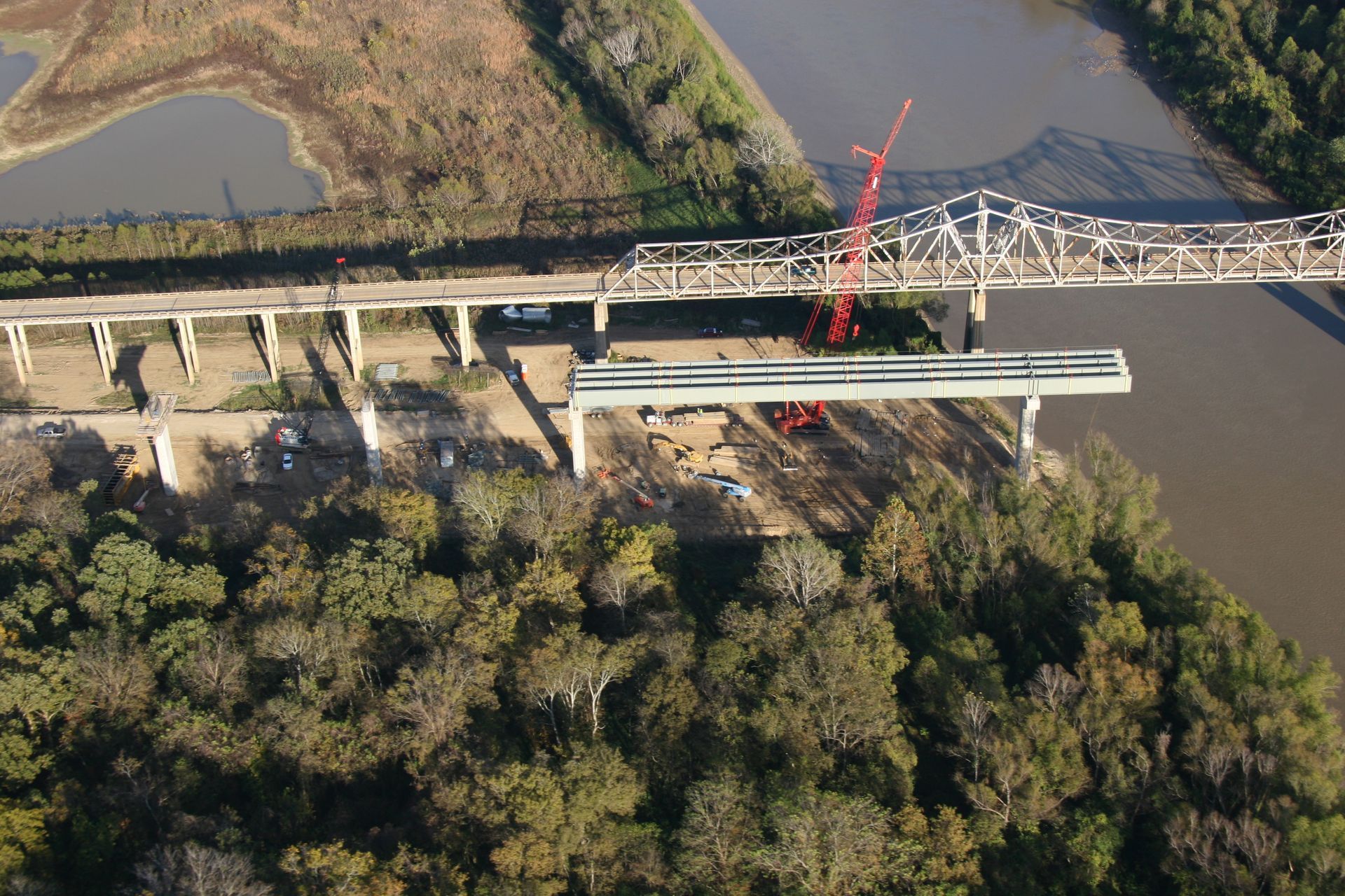 An aerial view of a bridge being built over a river