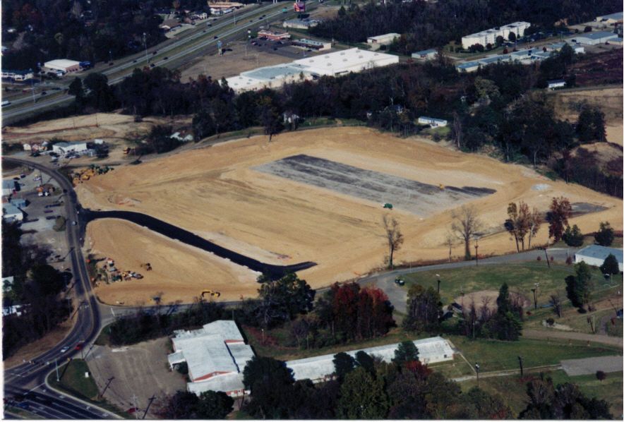 An aerial view of a large empty field in the middle of a city