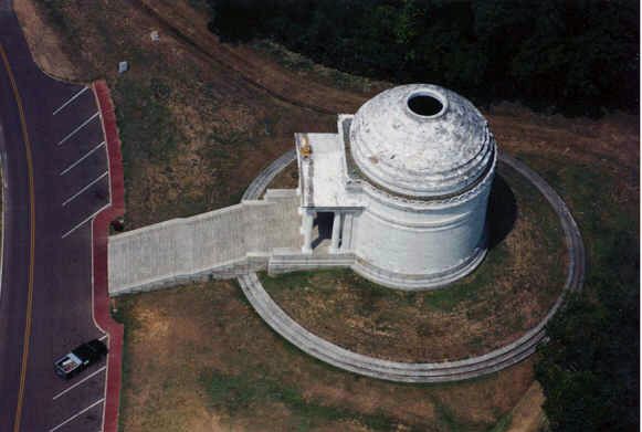 An aerial view of a dome in the middle of a parking lot.