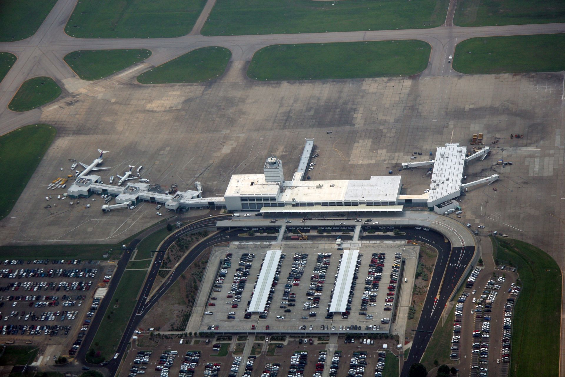 An aerial view of an airport with a lot of parking spaces