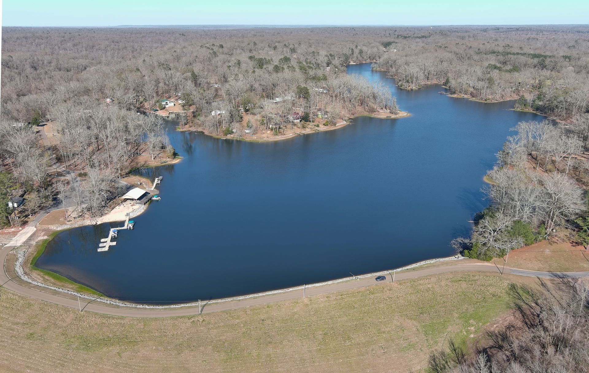 An aerial view of a large lake surrounded by trees
